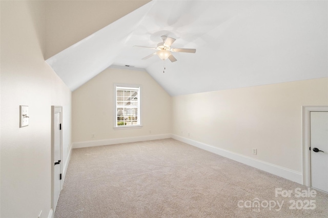 bonus room with baseboards, carpet floors, lofted ceiling, and ceiling fan