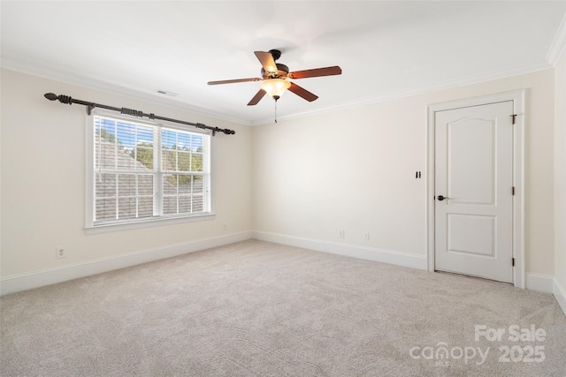 carpeted spare room with baseboards, visible vents, and ornamental molding