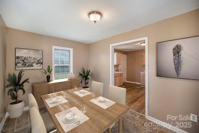 dining room featuring baseboards