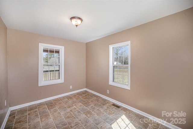 unfurnished room featuring visible vents and baseboards