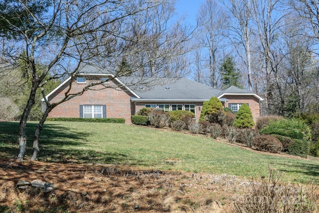 view of front of property with a front yard and brick siding