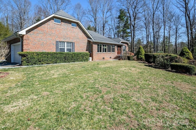 view of side of property featuring a yard, brick siding, and a garage