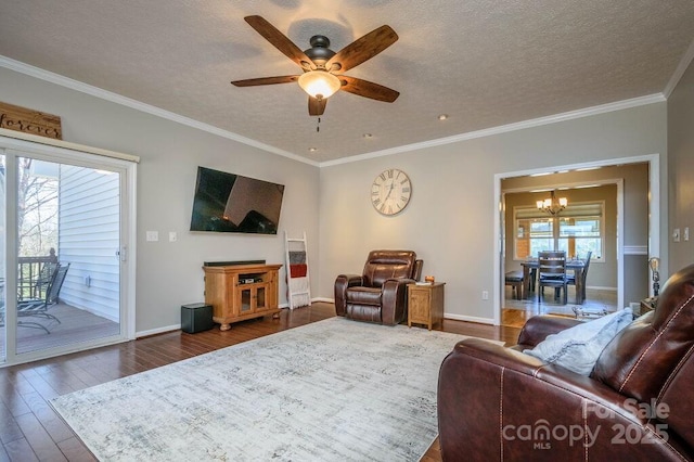 living area featuring dark wood-type flooring, ceiling fan with notable chandelier, baseboards, and a textured ceiling