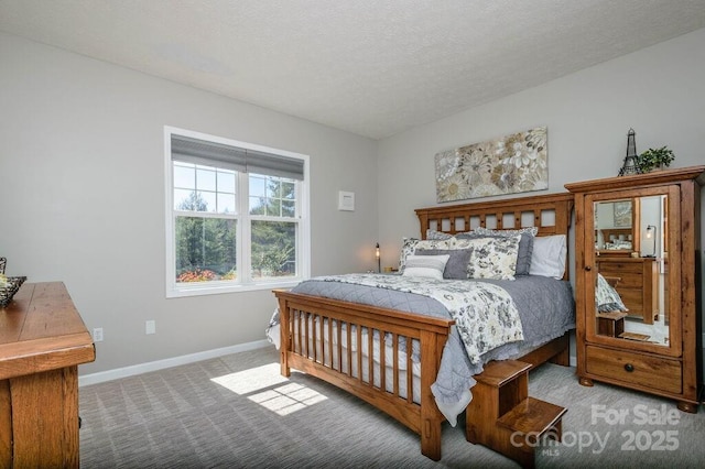 carpeted bedroom featuring a textured ceiling and baseboards