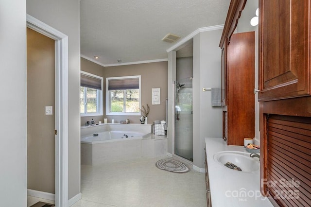 bathroom featuring a stall shower, crown molding, baseboards, a bath, and vanity