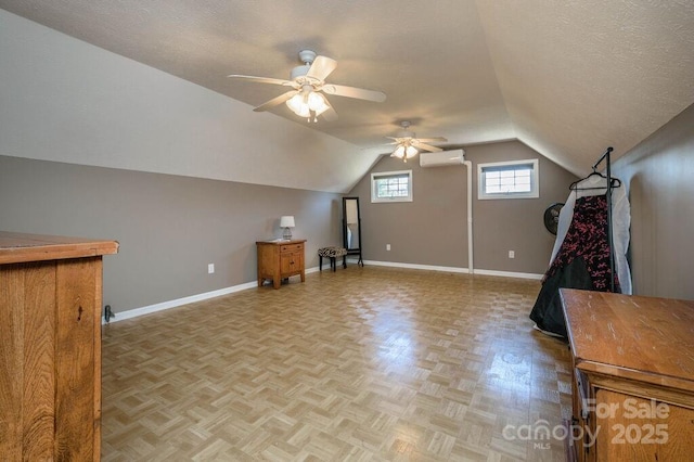 additional living space with baseboards, ceiling fan, and vaulted ceiling