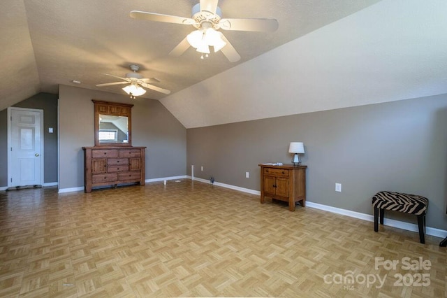 bonus room with a textured ceiling, baseboards, a ceiling fan, and vaulted ceiling