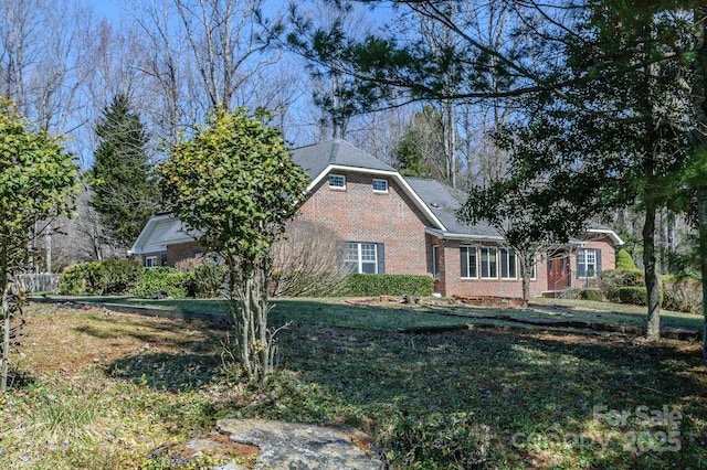 view of side of home featuring brick siding