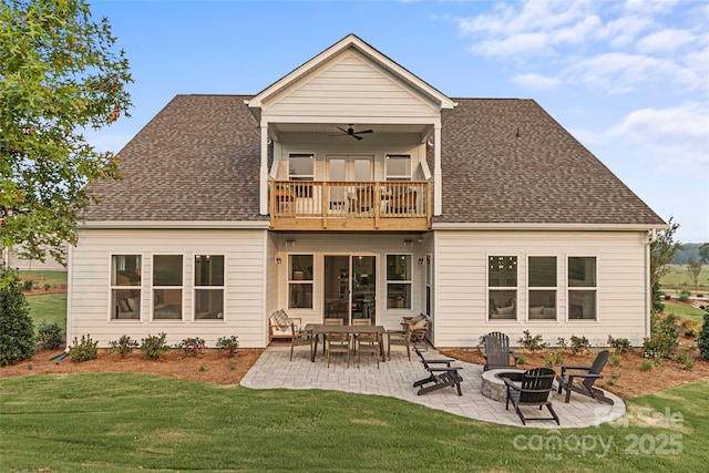 rear view of property featuring a yard, a balcony, roof with shingles, and ceiling fan