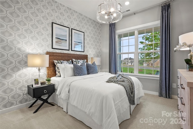 bedroom featuring an inviting chandelier, baseboards, light carpet, and wallpapered walls