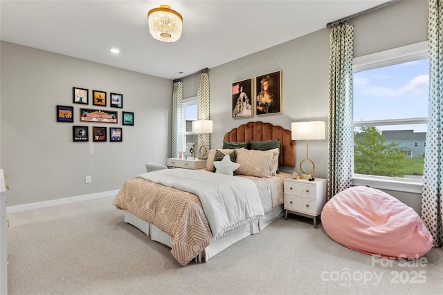 bedroom featuring carpet and baseboards