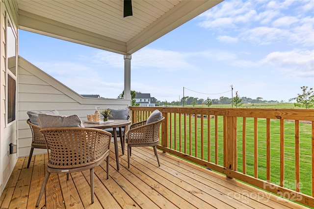 wooden terrace with a lawn