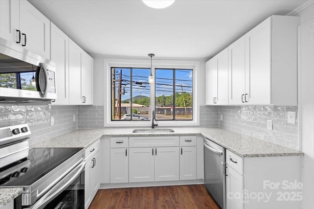 kitchen featuring a sink, dark wood-style flooring, white cabinetry, and stainless steel appliances