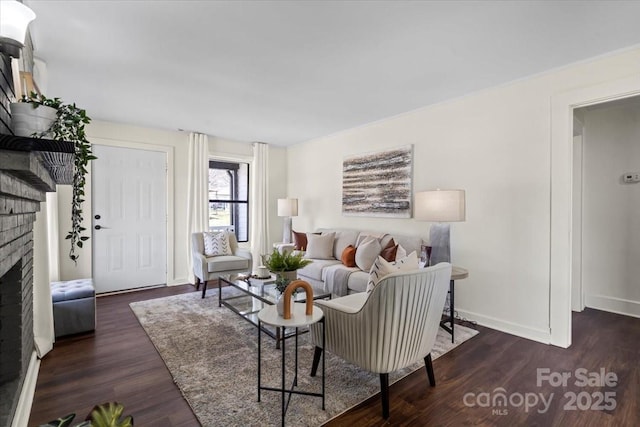 living area featuring wood finished floors, a fireplace, and baseboards