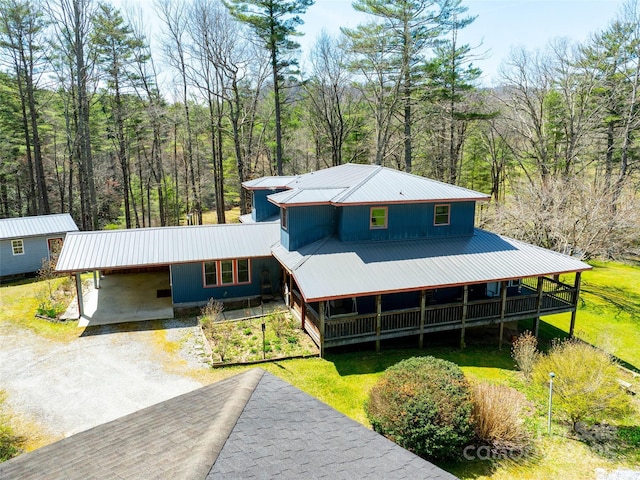 140 Hangin Dog Ln, Lake Toxaway, NC 28747 - view of front facade featuring a carport, a wooded view, driveway, metal roof, and covered porch