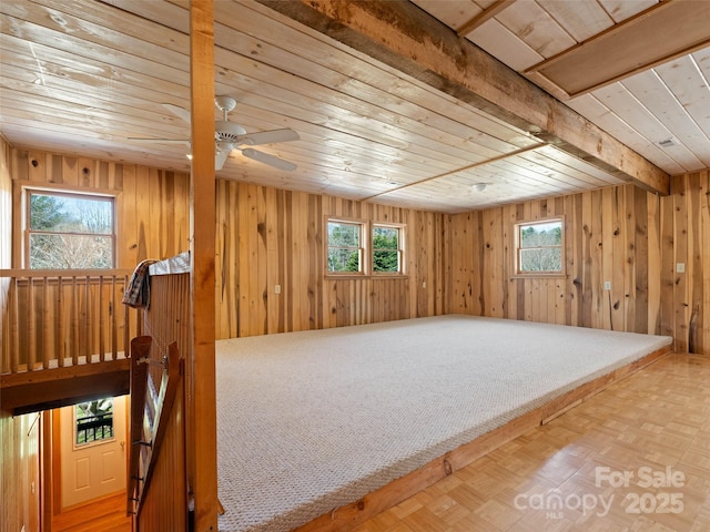 140 Hangin Dog Ln, Lake Toxaway, NC 28747 - interior space with wooden walls, wood ceiling, beam ceiling, and ceiling fan