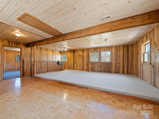 140 Hangin Dog Ln, Lake Toxaway, NC 28747 - spare room featuring wooden walls, visible vents, a wealth of natural light, and parquet flooring