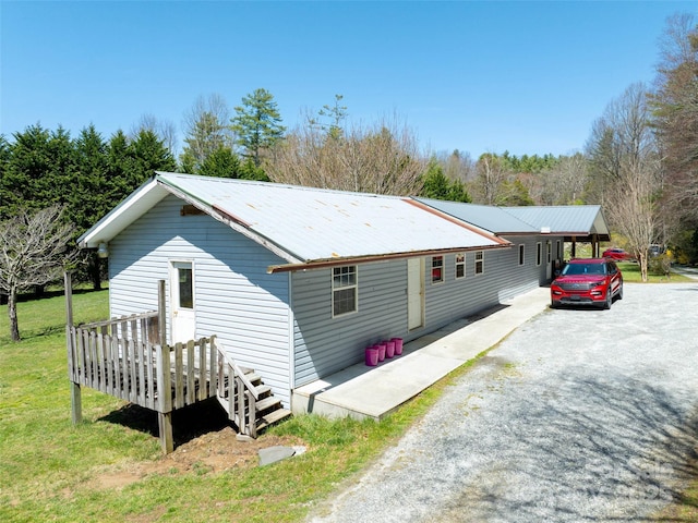 140 Hangin Dog Ln, Lake Toxaway, NC 28747 - view of side of property featuring a wooden deck, a yard, metal roof, and gravel driveway