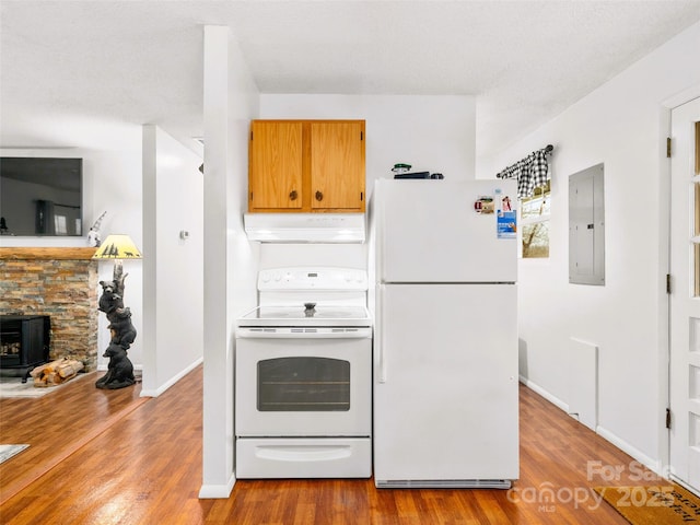 kitchen featuring under cabinet range hood, electric panel, wood finished floors, white appliances, and baseboards