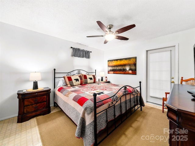 bedroom with ceiling fan and a textured ceiling