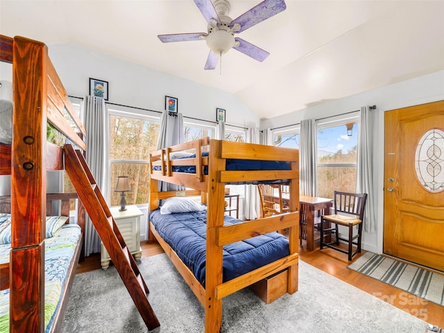 bedroom featuring lofted ceiling and wood finished floors