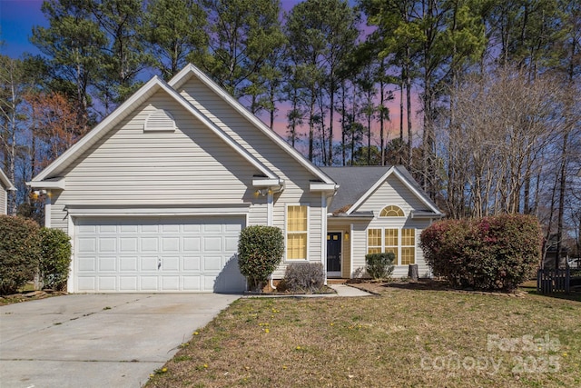 traditional-style house featuring a garage, a front lawn, and driveway