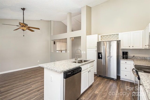 kitchen featuring a sink, dark wood finished floors, a center island with sink, and stainless steel appliances