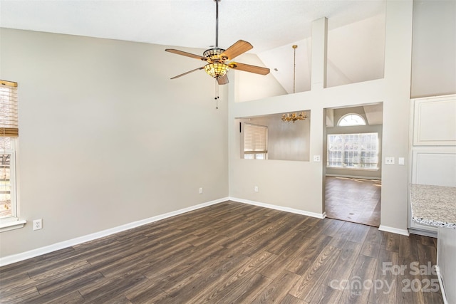 unfurnished room with ceiling fan, high vaulted ceiling, dark wood-type flooring, and baseboards