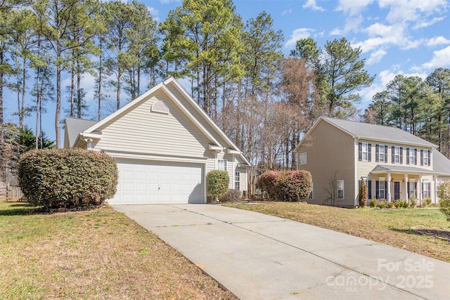 view of front of house with a garage, concrete driveway, and a front yard