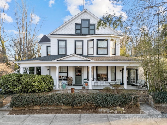 view of front of property with covered porch and a shingled roof