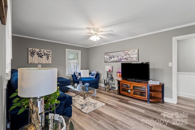 living room with ornamental molding, baseboards, a ceiling fan, and wood finished floors