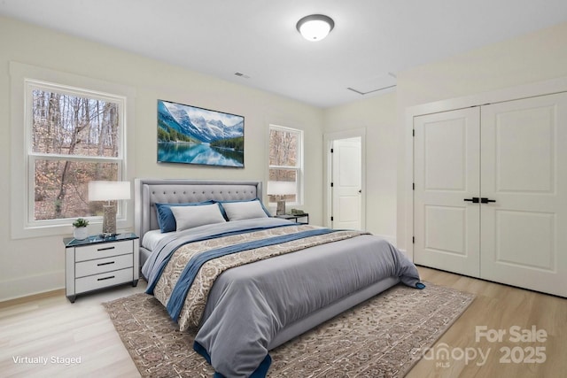 10405 Briarhurst Pl Unit 18, Mint Hill, NC 28227 - bedroom with light wood-type flooring, a closet, and baseboards
