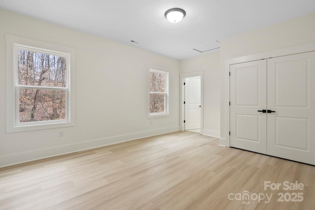10405 Briarhurst Pl Unit 18, Mint Hill, NC 28227 - unfurnished bedroom featuring light wood-style floors, baseboards, and a closet