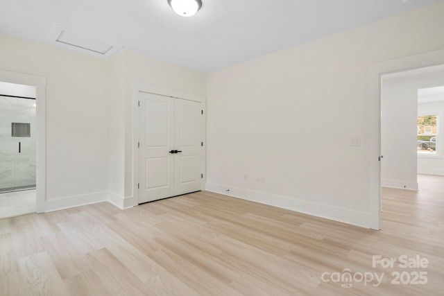 10405 Briarhurst Pl Unit 18, Mint Hill, NC 28227 - unfurnished room featuring light wood finished floors, attic access, and baseboards