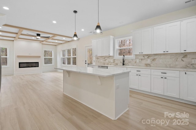 10405 Briarhurst Pl Unit 18, Mint Hill, NC 28227 - kitchen with a sink, light wood-type flooring, backsplash, ceiling fan, and recessed lighting