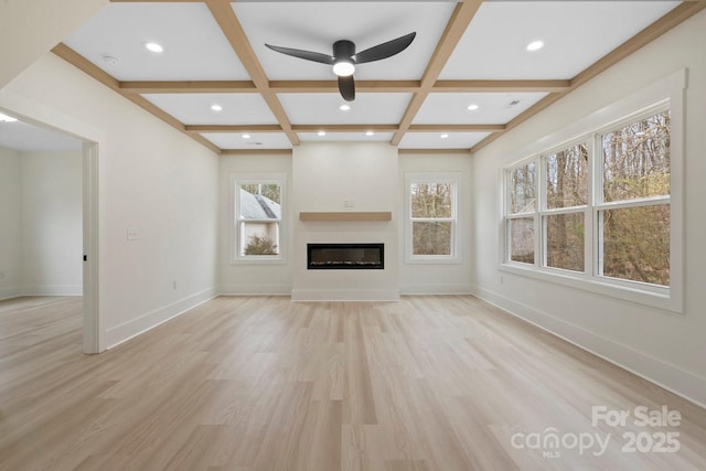 10405 Briarhurst Pl Unit 18, Mint Hill, NC 28227 - unfurnished living room featuring coffered ceiling, healthy amount of natural light, light wood finished floors, ceiling fan, and beamed ceiling