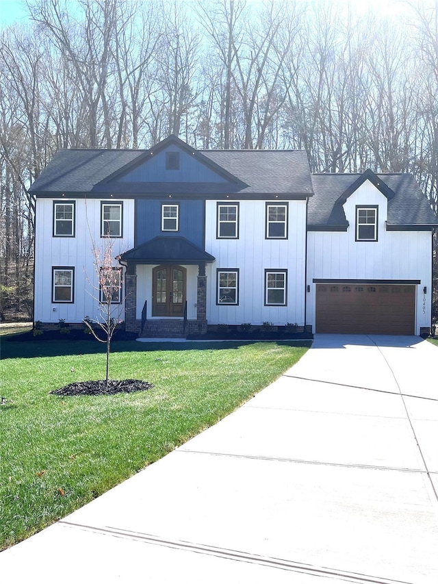 10405 Briarhurst Pl Unit 18, Mint Hill, NC 28227 - modern inspired farmhouse with concrete driveway, a front yard, an attached garage, and board and batten siding