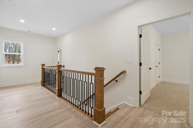 10405 Briarhurst Pl Unit 18, Mint Hill, NC 28227 - hall featuring an upstairs landing, wood finished floors, baseboards, and recessed lighting