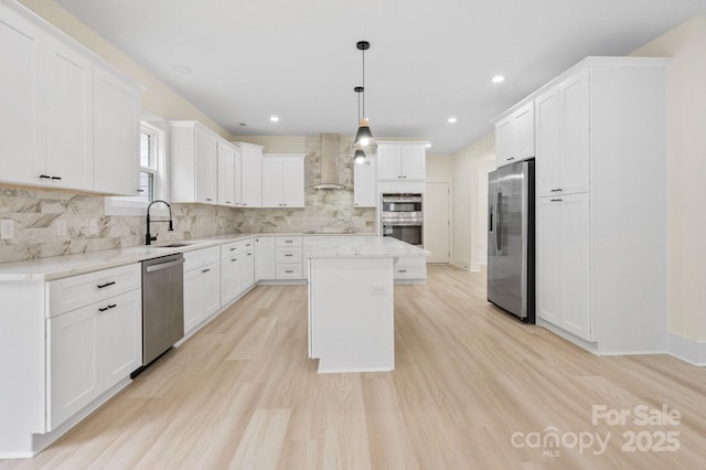 10405 Briarhurst Pl Unit 18, Mint Hill, NC 28227 - kitchen with stainless steel appliances, wall chimney exhaust hood, a kitchen island, tasteful backsplash, and white cabinetry