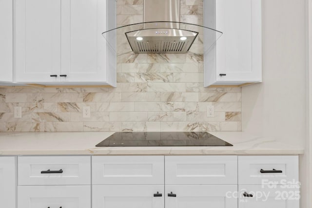 10405 Briarhurst Pl Unit 18, Mint Hill, NC 28227 - kitchen with wall chimney range hood, black electric stovetop, white cabinets, and tasteful backsplash