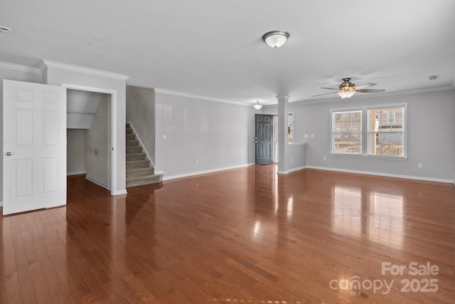 unfurnished living room with stairway, baseboards, wood finished floors, and crown molding