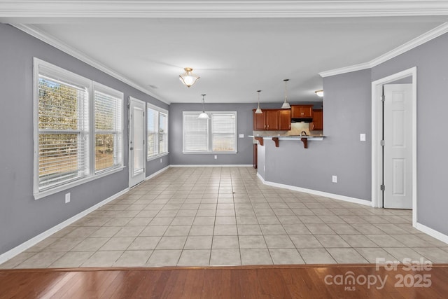 unfurnished living room featuring baseboards, light tile patterned flooring, and crown molding