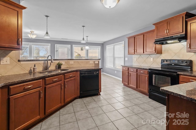 kitchen featuring plenty of natural light, a sink, black appliances, under cabinet range hood, and pendant lighting