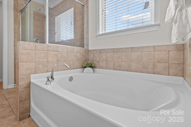 full bathroom featuring tile patterned floors, a stall shower, and a bath