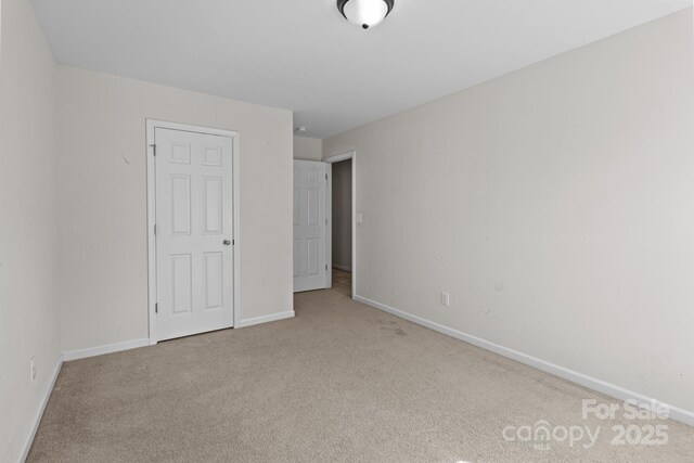 unfurnished bedroom featuring baseboards and carpet floors