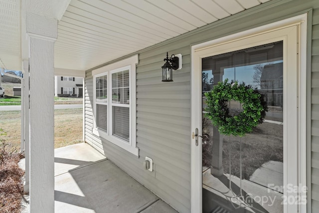 view of exterior entry with covered porch