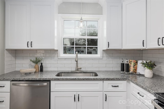 kitchen with decorative backsplash, white cabinets, stainless steel appliances, and a sink