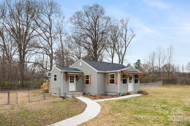 view of front of house with a gate, fence, roof with shingles, a front lawn, and crawl space