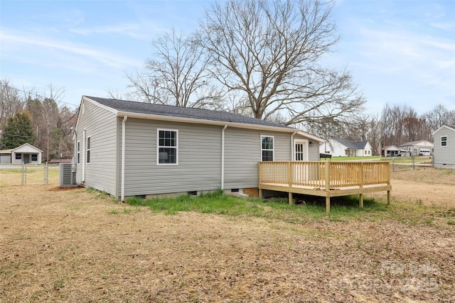 back of property with central air condition unit, a deck, and fence