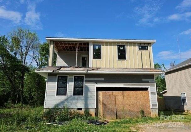 back of house featuring crawl space, board and batten siding, and an attached garage